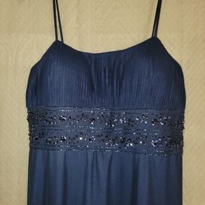 Blue evening gown with beaded bodice and tulle overlay.